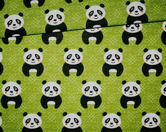 Panda fabric on a green background in cotton printed oeko tex