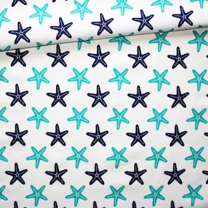 Turquoise and navy blue starfish fabric on a white cotton background printed oeko tex