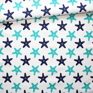 Turquoise and navy blue starfish fabric on a white background in printed cotton oeko tex