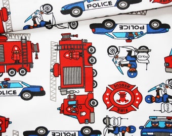 Fabric fire trucks and police cars on a white background in cotton printed oeko tex