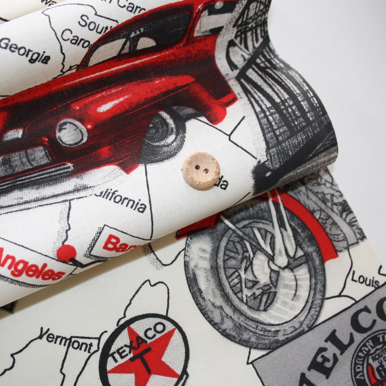 May include: A white fabric with a red, black and grey print of a vintage car, a motorcycle and a map of the United States. The fabric features the text "TEXACO" and "WELCOME".