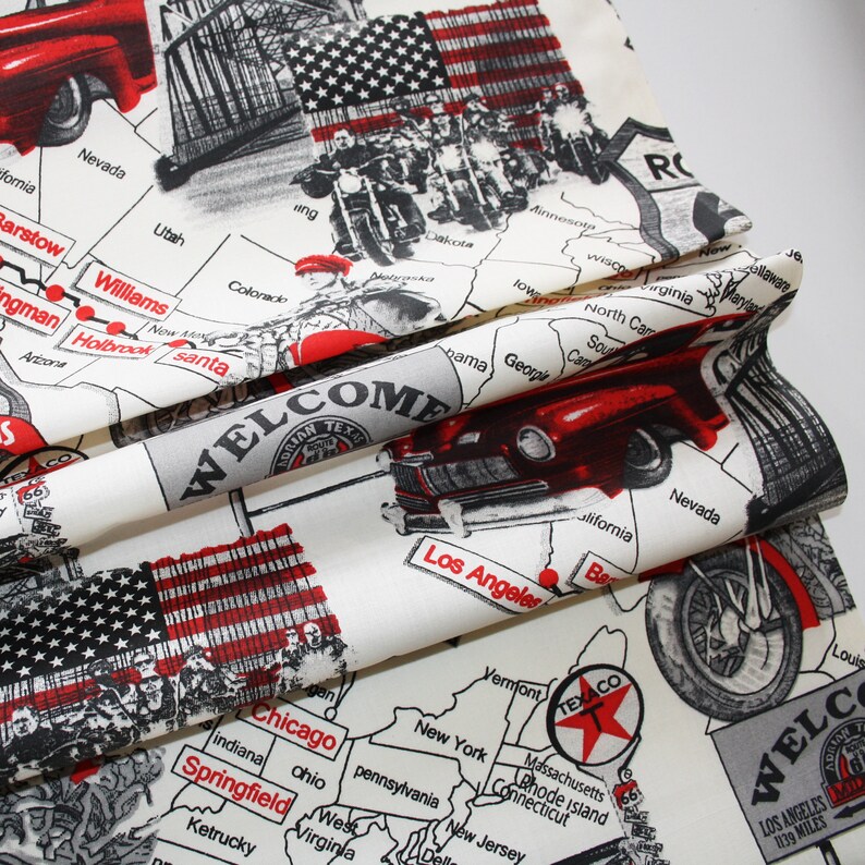 May include: A white fabric with a red, white and blue Americana theme. The fabric features a map of the United States with state names, a vintage car, motorcycles and the text "Welcome to Texas".