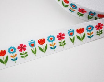 2 m of coarse grain ribbon 20 mm colored flowers on a white background