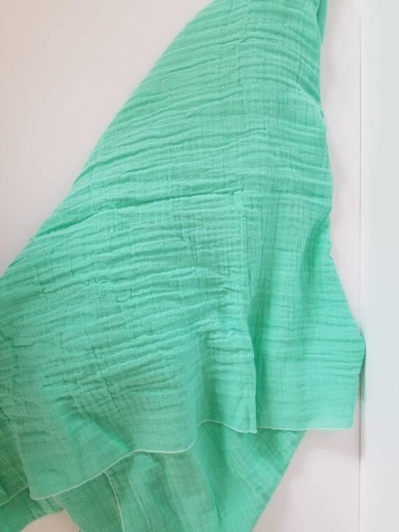 green muslin blanket