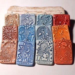 Choose from a rectangular pendant in handcrafted ceramic, featuring a zodiac sign, air or water element, in turquoise blue tones; a unique piece of jewelry, perfect as a gift.