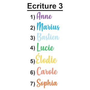 May include: A list titled Ecriture 3 featuring seven names in cursive font: 1) Anne in purple, 2) Marius in blue, 3) Bastien in light blue, 4) Lucie in green, 5) &Eacute;lodie in yellow, 6) Carole in coral, and 7) Sophia in orange, with a butterfly logo.