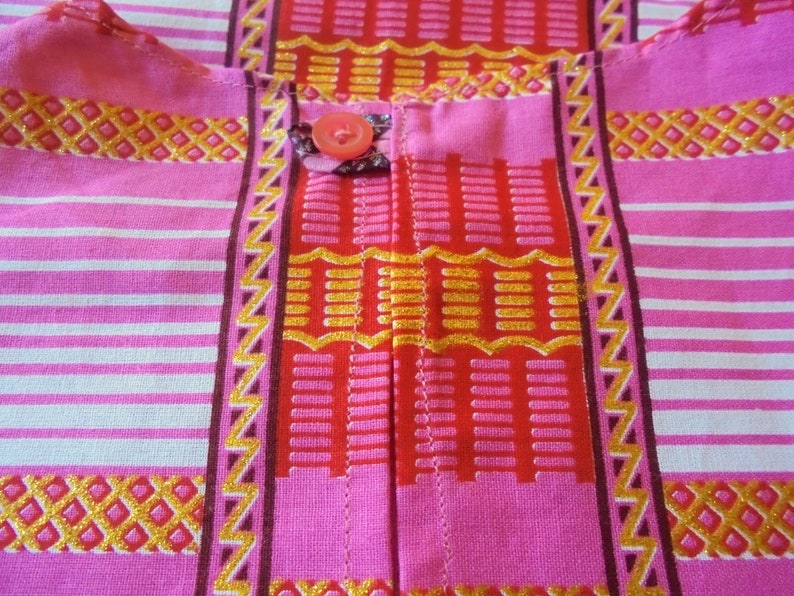 Summer 18 months 2 years and 3 years girl dress printed on a pink background and pink wax.