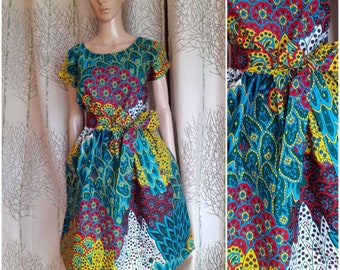Several lengths, African style dress in African style wax print with peacock feathers and flowers