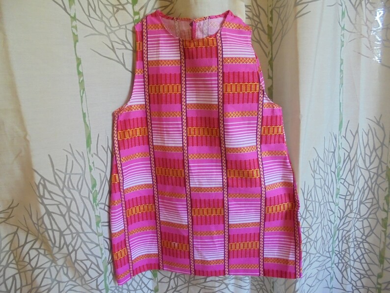 Summer 18 months 2 years and 3 years girl dress printed on a pink background and pink wax.