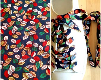 Dark blue cotton laces printed with small leaves, multicolored foliage