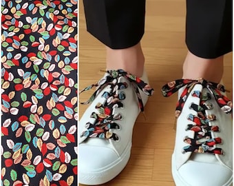 Black cotton laces printed with small leaves, multicolored foliage