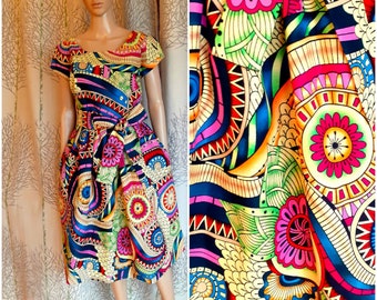 Several lengths, African style dress in wax rosettes target flared mandala disc