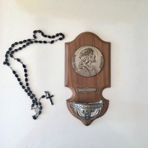 Antique wooden wall-mounted holy water font