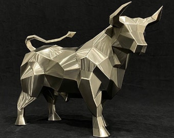 May include: A silver geometric bull sculpture with a faceted design. The sculpture is standing on a black surface.
