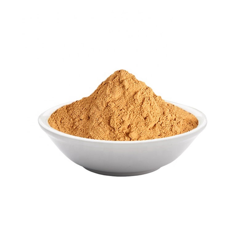 May include: A white bowl filled with a mound of light brown powder.