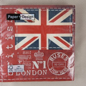 May include: Red and blue paper napkins featuring a Union Jack design and the text "Paper + Design tabletop" and "Buses to City Stop Here" with a vintage London bus stamp.