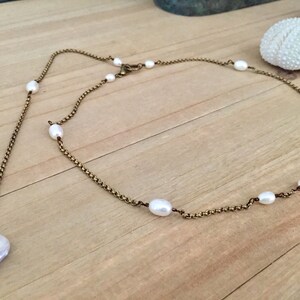 Fernanda necklace featuring hand wrapped AAA freshwater pearls and long back pendant