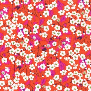 Può includere: Un motivo senza cuciture con fiori bianchi con centri verdi su uno sfondo arancione brillante. I fiori sono disposti in un motivo ripetitivo, creando un design floreale.