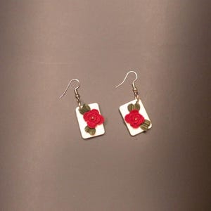 White envelope-shaped earrings with a red flower