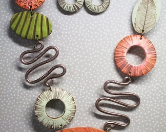 Leaf-effect necklace with orange, green and brown polymer clay earrings.