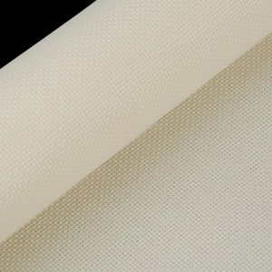 May include: Close-up of a rolled-up, off-white cross-stitch fabric. The fabric has a grid-like pattern of small holes, ideal for needlework projects. The texture is visible, with a slight sheen. The background is black.
