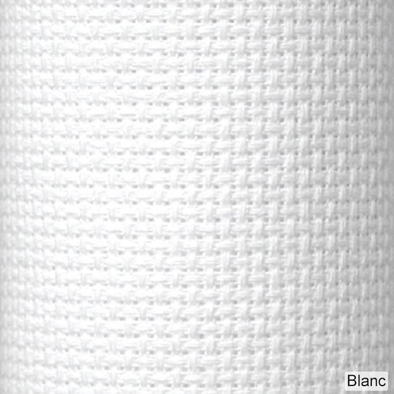 May include: Close-up of a white woven fabric with a textured surface. The fabric has a basketweave pattern, with the word "Blanc" in the bottom right corner.