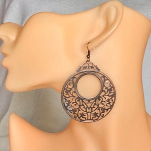 Large round copper-plated earrings, openwork and filigree lace and arabesques. Light, fine, very wide. Baroque.