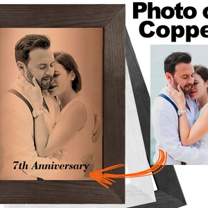 May include: A framed photo on copper with a couple embracing. The photo is in a brown wood frame and has the text "7th Anniversary" inscribed below the image.