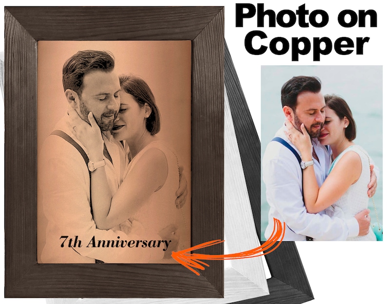 May include: A framed photo on copper with a couple embracing. The photo is in a brown wood frame and has the text "7th Anniversary" inscribed below the image.