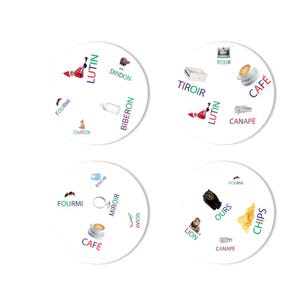 May include: Four circular game cards with colorful illustrations and French words. Each card features a different set of images, including a coffee cup, a lion, a baby bottle, and a Santa-like figure. The cards are white with black text.