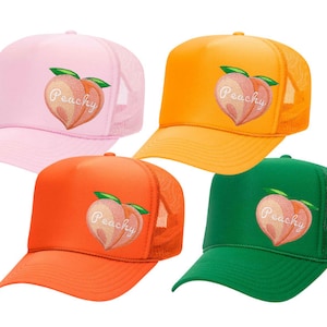 May include: Four trucker hats with a peach design and the word "Peachy" embroidered on the front. The hats are in pink, orange, green, and blue.