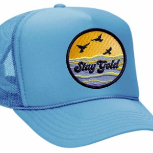 May include: A light blue trucker hat with a yellow and blue embroidered patch that says "Stay Gold" with three birds flying over a yellow sun.