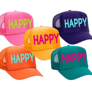 May include: Five trucker hats in different colors with the word "HAPPY" in neon colors on the front. The hats are pink, orange, yellow, teal, and purple.
