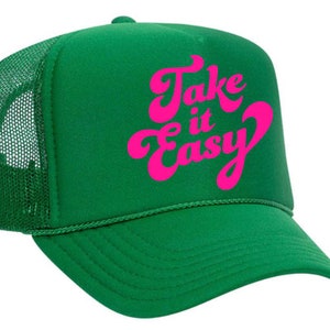 May include: Green trucker hat with a pink "Take it Easy" graphic in a retro font.