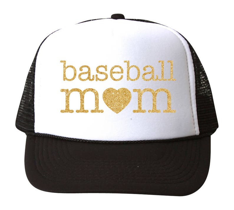 May include: A white and black trucker hat with a gold glitter design that says "baseball mom" with a gold glitter heart in the middle.