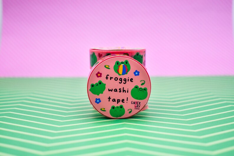 May include: Pink and green frog-themed washi tape with the text "froggy washi tape!" and the brand name "Ginger Bay Studios".