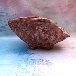 Może przedstawiać: Zestaw trzech ceramicznych kubków z nakrapianym, matowym wykończeniem. Kubki są w odcieniach kremu, szarości i czerni. Każdy kubek ma prosty, nowoczesny design, idealny do kawy lub herbaty. Kubki są ułożone jeden na drugim.