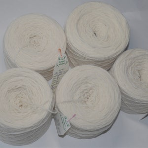 May include: Five white yarn balls with labels attached. The labels have green and white text that reads "The Fine Philippine"