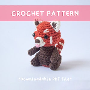 May include: Crochet pattern for a red panda amigurumi. The pattern is available as a downloadable PDF file. The red panda is sitting with its tongue sticking out.