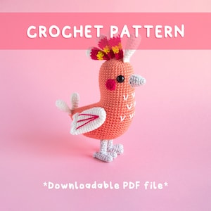 May include: A crochet pattern for a pink bird with a white and pink wing, a red and yellow crest, and white feet. The pattern is downloadable as a PDF file. *Downloadable PDF file*