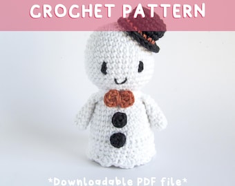 May include: A handmade white crochet snowman with a small black and red hat, an orange bow tie, and black buttons. The text "CROCHET PATTERN" is displayed above the snowman, and "*Downloadable PDF file*" is below.