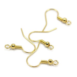 May include: Three gold-toned earring hooks with a small ball at the end of each hook.