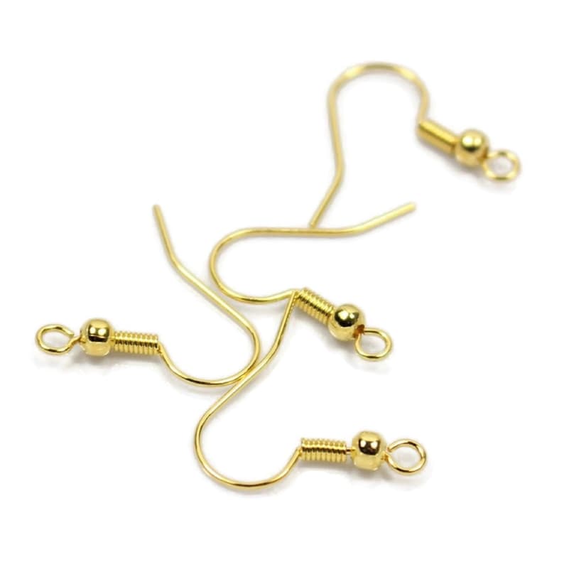 May include: Three gold-toned earring hooks with a small ball at the end of each hook.