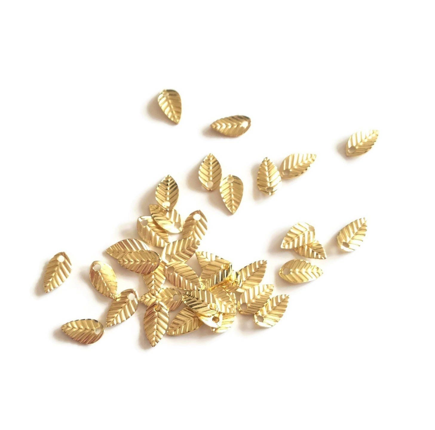 x50 Mini leaf charms, 7mm, golden raw brass