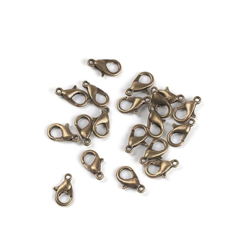 May include: A group of 20 antique gold-toned metal lobster clasps. These clasps are perfect for jewelry making, crafting, and DIY projects.