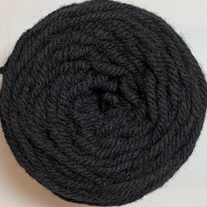 May include: A black skein of yarn.