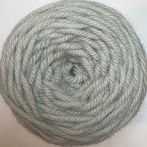 May include: A skein of light gray yarn, wound into a ball.