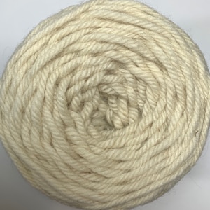 May include: A skein of natural white yarn, wound into a ball shape.
