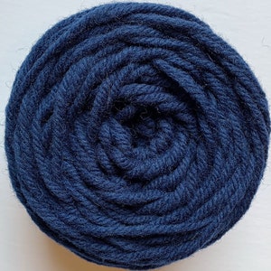 May include: A skein of dark blue yarn, wound into a tight circle.