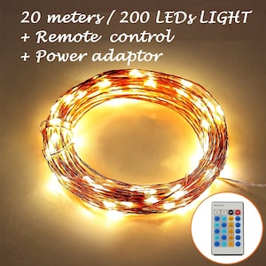 May include: A string of 200 warm white LED lights, coiled up on a white surface. The lights are 20 meters long and come with a remote control and power adapter. The text on the image reads "20 meters / 200 LEDs LIGHT + Remote control + Power adaptor".
